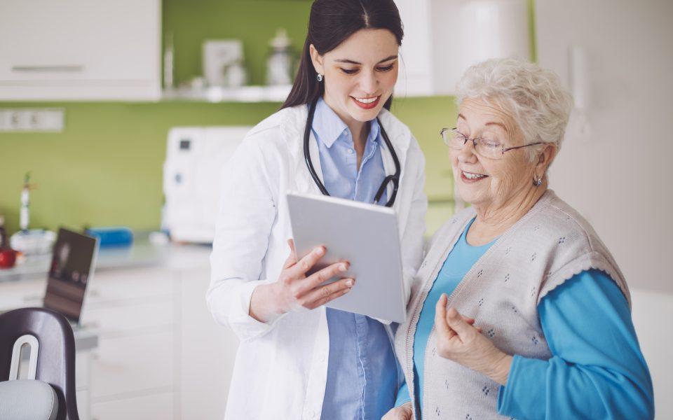 Female doctor consulting with senior female patient